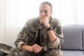 Nervous male military suffering depression, sitting alone at home, PTSD concept Royalty Free Stock Photo