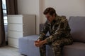 Nervous male military suffering depression, sitting alone at home, PTSD concept. Royalty Free Stock Photo