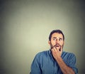 Nervous stressed young man student biting fingernails looking up Royalty Free Stock Photo