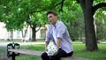 Nervous teen waiting for girlfriend with flowers bouquet, failed date, break up