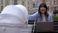 Nervous working mother trying finish project on laptop and feed baby with milk Royalty Free Stock Photo