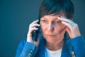 Nervous worried businesswoman during unpleasant telephone conversation Royalty Free Stock Photo