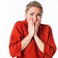 Nervous young blond woman hiding her face for worry and fear Royalty Free Stock Photo