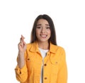 Nervous young woman holding fingers crossed on white background. Superstition for good luck Royalty Free Stock Photo