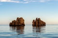 Nes Portes Rocks with a cross on top, north of Paros Island sticking out from perfectly flat calm Mediterranean Sea, Greece Royalty Free Stock Photo