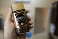 Nescafe Gold coffee can in a hand with copy space