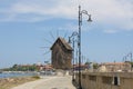NESEBAR, BULGARIA - JUNE 07, 2019: windmill and road to old historical centre of the town Nesebar, UNESCO World heritage