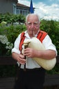 Nesebr, Bulgaria - 16 June, 2013: An elderly gray-haired man is holding a gaida. Traditional spiritual musical instrument Bulgaria