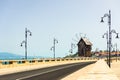 Empty road and wooden wind mill at the isthmus of Nessebar, Bulgaria Royalty Free Stock Photo