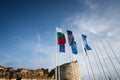 Nessebar, Bulgaria - June 2023: Flag of waving Bulgaria and UNESCO in the wind against the blue sky