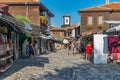 Nessebar, Bulgaria - 2 Sep 2018: Tourists on the beautiful streets of Nesebar ancient city on a sunny day with blue sky. Nessebar