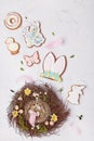 Nest decoration with eggs and Easter cookies glazed and decorated flat lay. Easter aesthetics