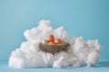 nest with eggs nestled atop a white, cottonwool cloud on blue backdrop Royalty Free Stock Photo
