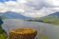A nest in the foreground and a view of the lake and mountains in nature