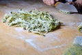 Nest of fresh nettle noodles on cutting borad