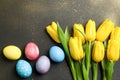 Nest with ÃÂolorful easter eggs, flowers and feathers on wooden background Royalty Free Stock Photo