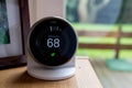 Nest smart thermostat on a table at living room