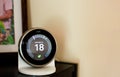 Nest smart thermostat on a table at living room