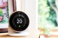 Nest smart thermostat on a table at living room