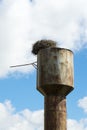 Nest stork on the old water tower. Against the sky. Royalty Free Stock Photo