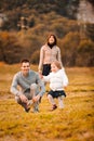 nestled at the foot of mountains, a family engages with an illustrated book Royalty Free Stock Photo