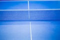 Net on blue ping pong table Royalty Free Stock Photo