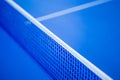 Net on blue ping pong table Royalty Free Stock Photo