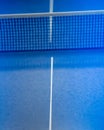 Net on blue ping pong table Royalty Free Stock Photo