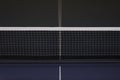 Net on blue ping pong tennis table Royalty Free Stock Photo