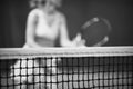 Net of tennis court on blur player background. Black and white