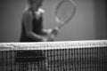 Net of tennis court on blur player background. Black and white
