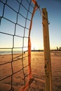 Net of volleyball on the beach and the sunset seen in the blurred background Royalty Free Stock Photo