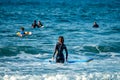 12/18/2018 Netanya, Israel, a surfer with a board goes swimming in the ocean at the dawn of the day