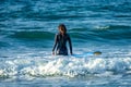 12/18/2018 Netanya, Israel, a surfer with a board goes swimming in the ocean at the dawn of the day