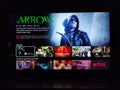 Netflix app on tv screen playing and the `Arrow ` series logo behind.