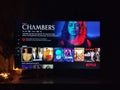 Netflix app on tv screen playing and the `Chambers` series logo behind Royalty Free Stock Photo