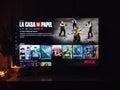 Netflix app on tv screen playing and the `La Casa De Papel` series logo behind