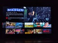 Netflix app on tv screen playing and the `The Matrix` series logo behind.