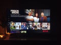 Netflix app on tv screen playing and the `Prison Break` series logo behind Royalty Free Stock Photo