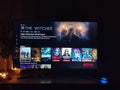 Netflix app on tv screen playing and the `The Witcher` series logo behind