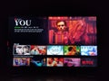 Netflix app on tv screen playing and the `You ` series logo behind.