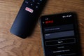 Netflix login on smartphone display. New password sharing rules on Netflix