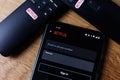 Netflix login on smartphone display. New password sharing rules on Netflix