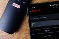 Netflix login on smartphone display. New password sharing rules on Netflix