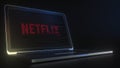 NETFLIX logo made with computer code on the laptop screen. Editorial conceptual 3d rendering