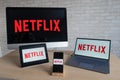 Netflix logo on the screens of all devices. Application for watching movies and TV shows stream right on a smartphone on