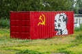 Red container with hammer and sickle, Lenin and Stalin