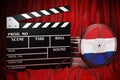 The Netherlands cinematography, film industry, cinema in the Netherlands. Clapperboard with and film reels on the red fabric, 3D