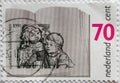 NETHERLANDS - CIRCA 1991: a postage stamp printed in the Netherlands showing a child reading from a book to another child. Text: p