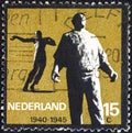 NETHERLANDS - CIRCA 1965: A stamp printed in the Netherlands shows Docker Amsterdam and Killed in Action Waalwijk, circa 1965.